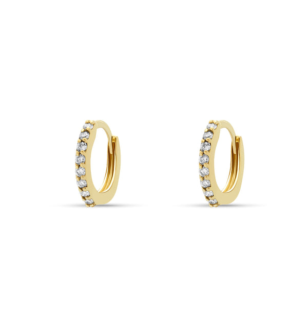 Our 14 karat gold huggie earrings feature handset diamond pave stones and are the ultimate essential for an every day sophisticated look.