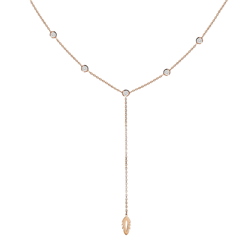 The enchanting 14 karat gold Feather Y Necklace features a feather perched along the bezel-set stone necklace. Each sparkling diamond cut stone is bezel set in 14k gold. 