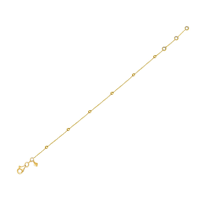 This gold anklet for day to night wear is made of 14 karat gold. The anklet features solid gold balls aligned on a delicate gold chain.