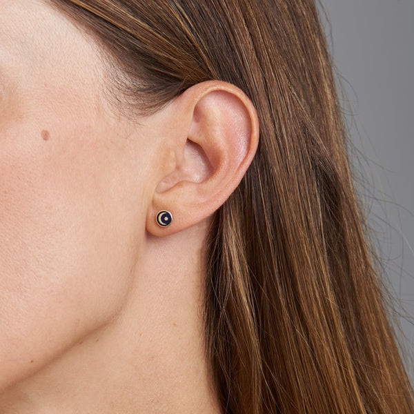 These handmade 14 karat gold diamond earring studs are the perfect every day gold accessory. The stud earrings feature a hand-painted blue enamel with a moon and a shining diamond star.