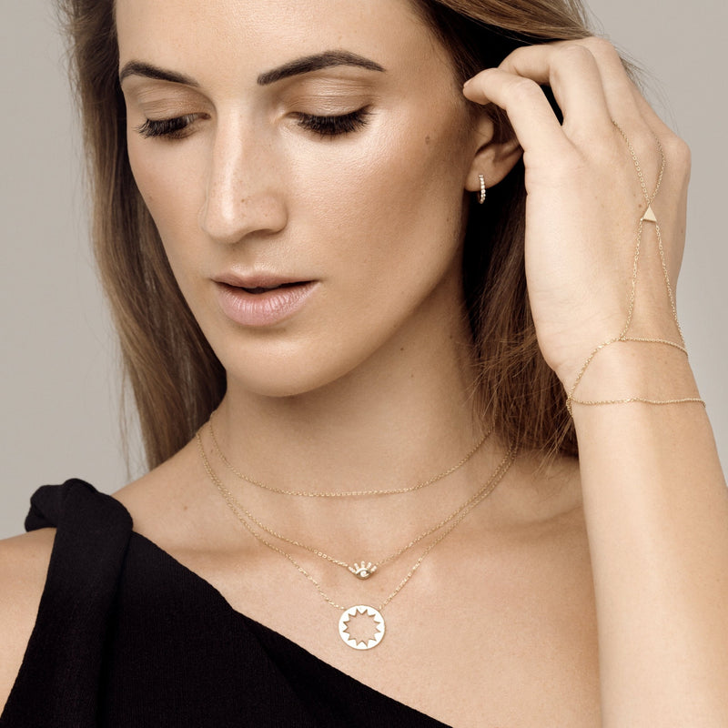 This 14 karat gold eye diamond necklace is our dream jewelry piece. The gold pendant necklace features pave set diamonds on the lashes and a bigger diamond stone in the center of the eye.