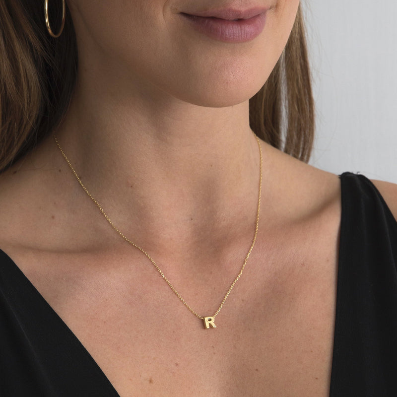 A 18 karat gold vermeil necklace with your initial letter "R". This diamond letter necklace is a special gold necklace that can be worn day and night. A genuine diamond stone in the corner of the letter makes this gold diamond necklace a luxury and ideal gift for yourself, your best friend or loved one.